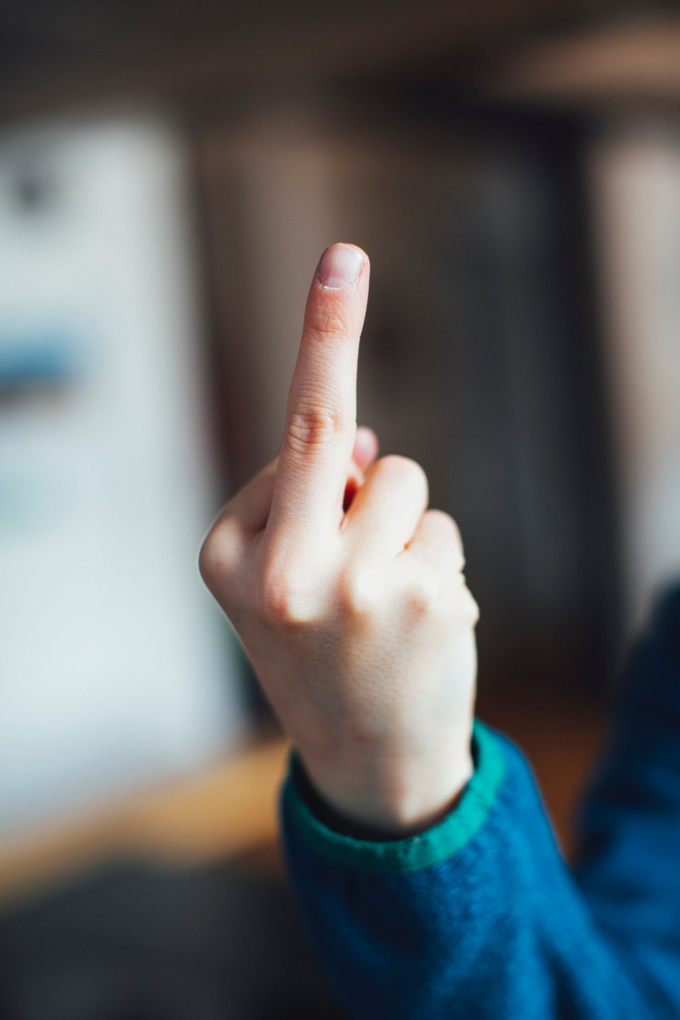 Young boy shows the middle finger – symbolic tell somebody to fuck off